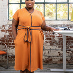 Full shot of the cinnamon dress in a lifestyle work environment