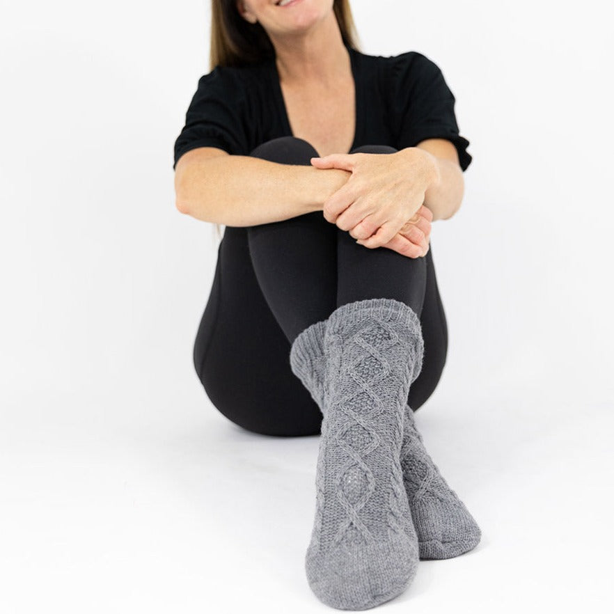 Gray socks with fleece lining. Silicone grippers on bottom for non-slip