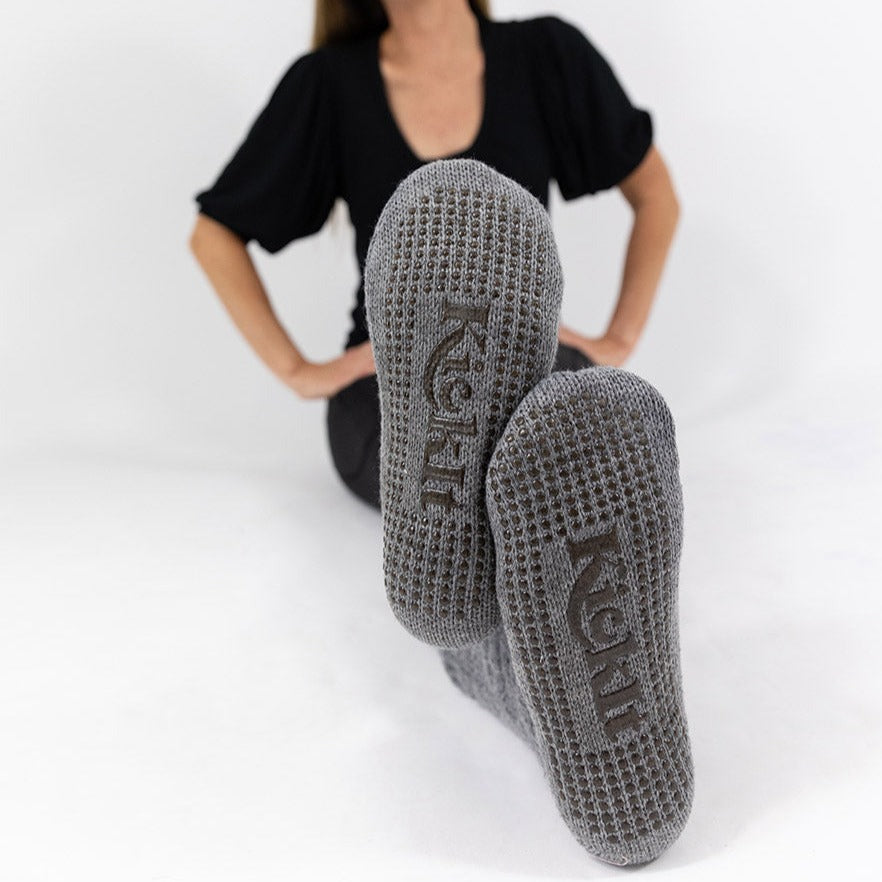 Gray socks with fleece lining. Silicone grippers on bottom for non-slip